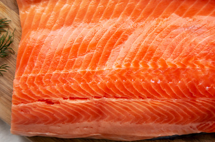 Organic Raw Salmon Fillet on a wooden board, top view. Flat lay,, a Food & Drink Photo by LiudmylaChuhunova