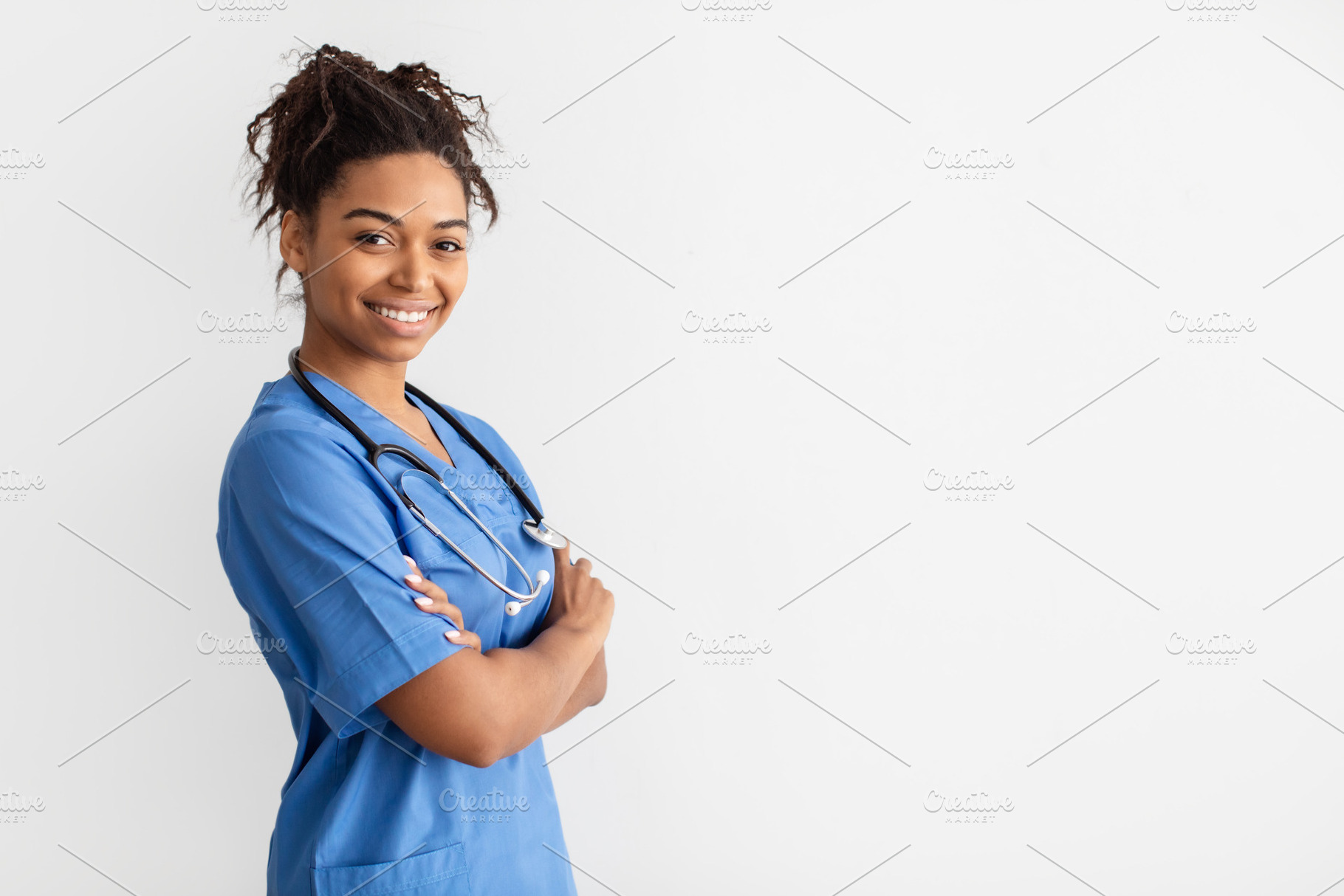 Portrait of black doctor looking at camera with folded arms, a Photo by Prostock-Studio