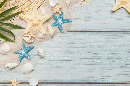 Summer accessories on blue wooden planks evoking beach holidays,