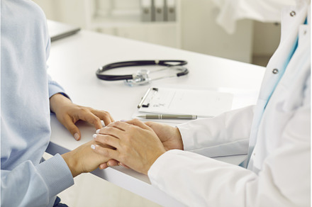 Doctor comforting young woman, a Health & Medical Photo by StudioRomantic