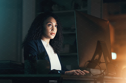 Night, office and black woman on computer for business project, management report and online document. Corporate worker, overtime and focused female working on strategy, planning and website research, a Photo by Peopleimages.com