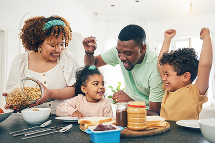 Love, breakfast food and happy black family children, mother and father eating meal, bonding and prepare ingredients. Morning, kitchen counter or hungry mom, dad and young youth kids excited at home, a Photo by Peopleimages.com