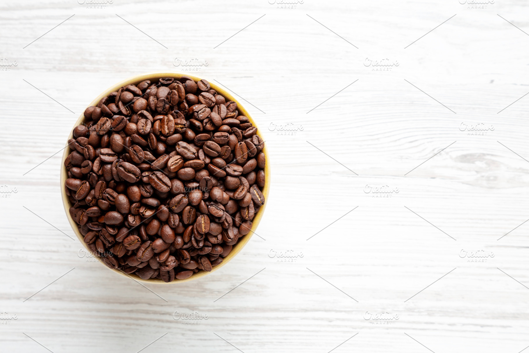 Organic Roasted Coffee Beans in a Bowl, top view. Copy space., a Food & Drink Photo by LiudmylaChuhunova