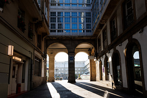 Looking through the arcades of Maria Pita Square in La Coruna, S, an Architecture Photo by Bepslabor
