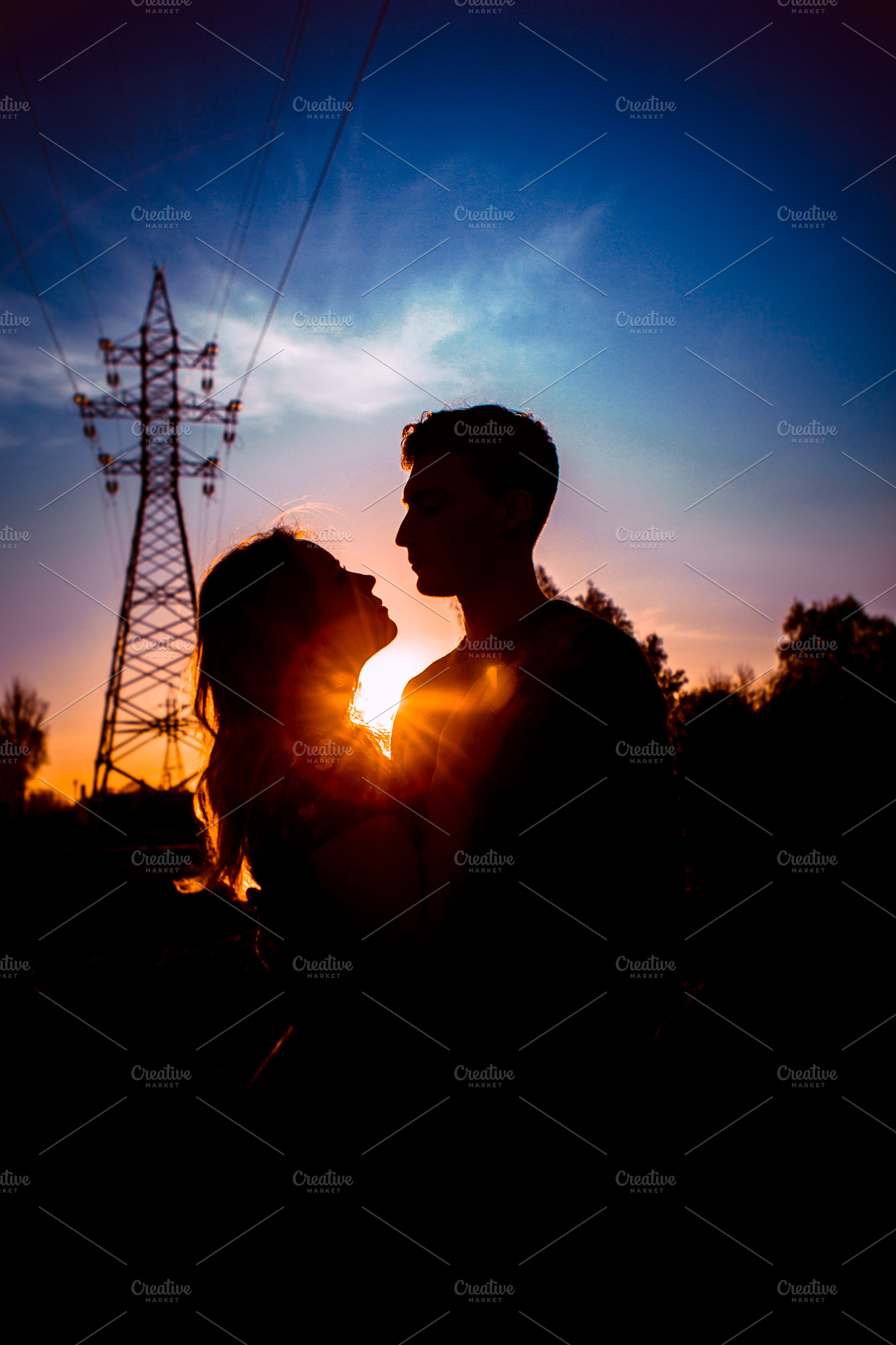 Silhouettes of a guy and girl in a field on a sunset background containing, a Person Photo by ruslan117