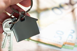 Hand holding house keys with money background, a Business Photo by Olena Rudo