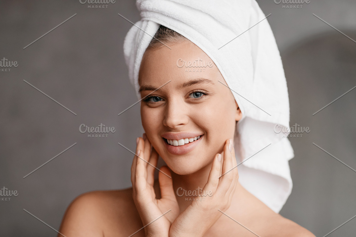 Home beauty routine. Young woman applying moisturising cream on face looking at, a Photo by Prostock-Studio (Photo 4 of 5)