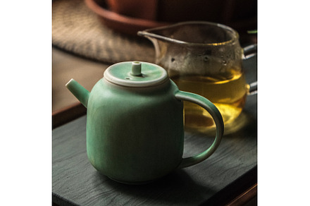 An Elegant Green Teapot Accompanied, a Food & Drink Photo by Media Whale Stock