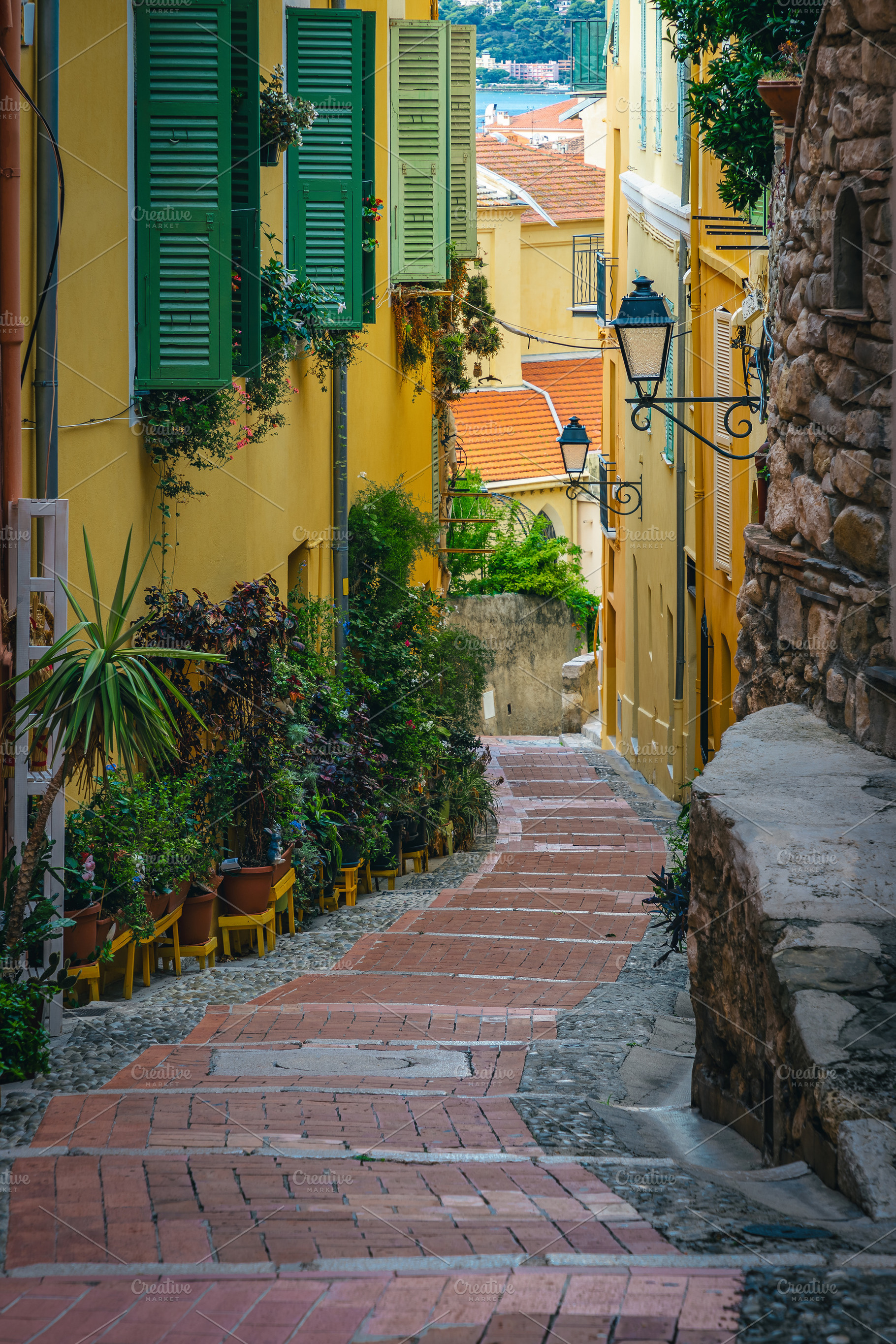 Narrow street with stairs in France, an Architecture Photo by Alpine Dreams
