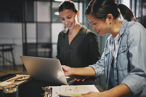 Smiling businesswomen working togeth containing adults, agency, and asian