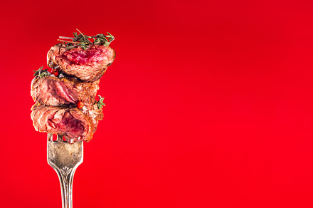 Pieces of beef steak on fork, a Food & Drink Photo by Rimma