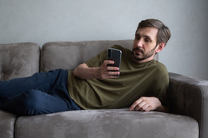Man lying comfortably on a modern, a Technology Photo by undrey