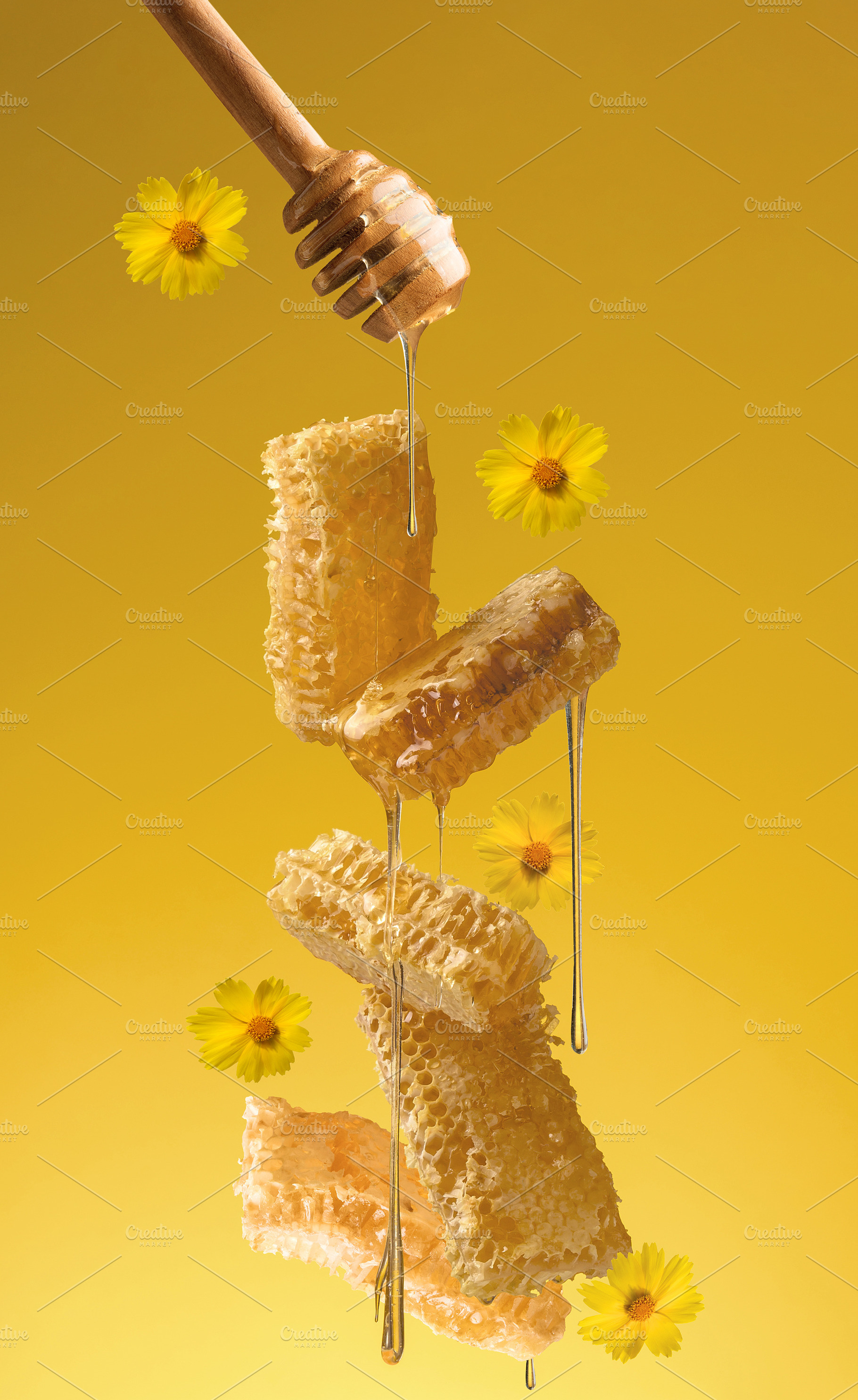 Fresh honey flows from a wooden spoon onto a levitating honeycom, a Food & Drink Photo by ndanko