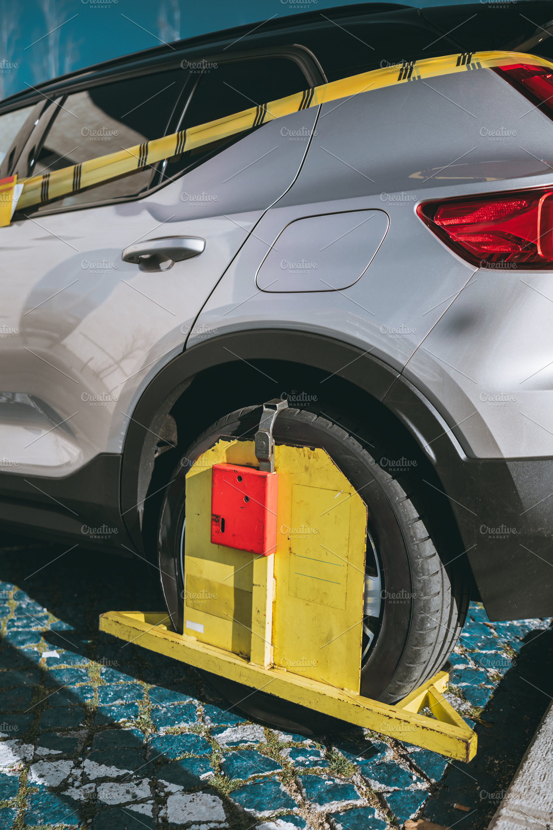 Car wheel immobilized, clamp device, a Transportation Photo by SkyNext