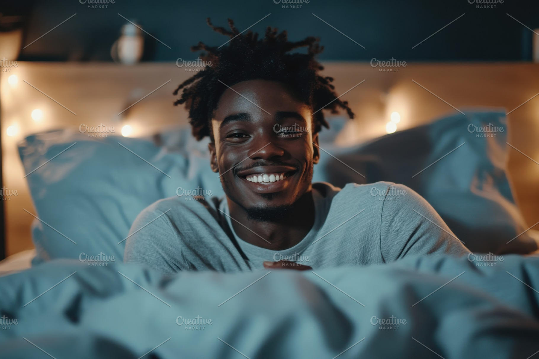 Smiling black man sitting on a bed i, a Photo by Iftikhar Alam