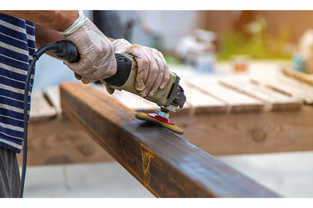 A man processes a metal pole, an Industrial Photo by yanadjana