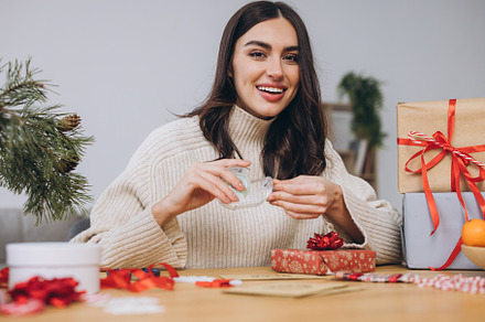Woman wrapping Christmas Presents Gifts
