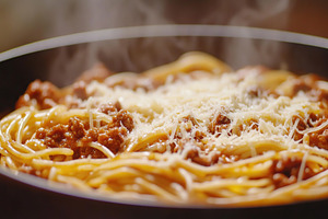 Spaghetti bolognese with ground beef on a frying pan, a Food & Drink Photo by AlyaAnd