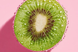 Fresh kiwi half with water droplets, a Food & Drink Photo by AlyaAnd