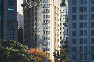 Sunlit historic tower in cityscape, an Architecture Photo by SkyNext