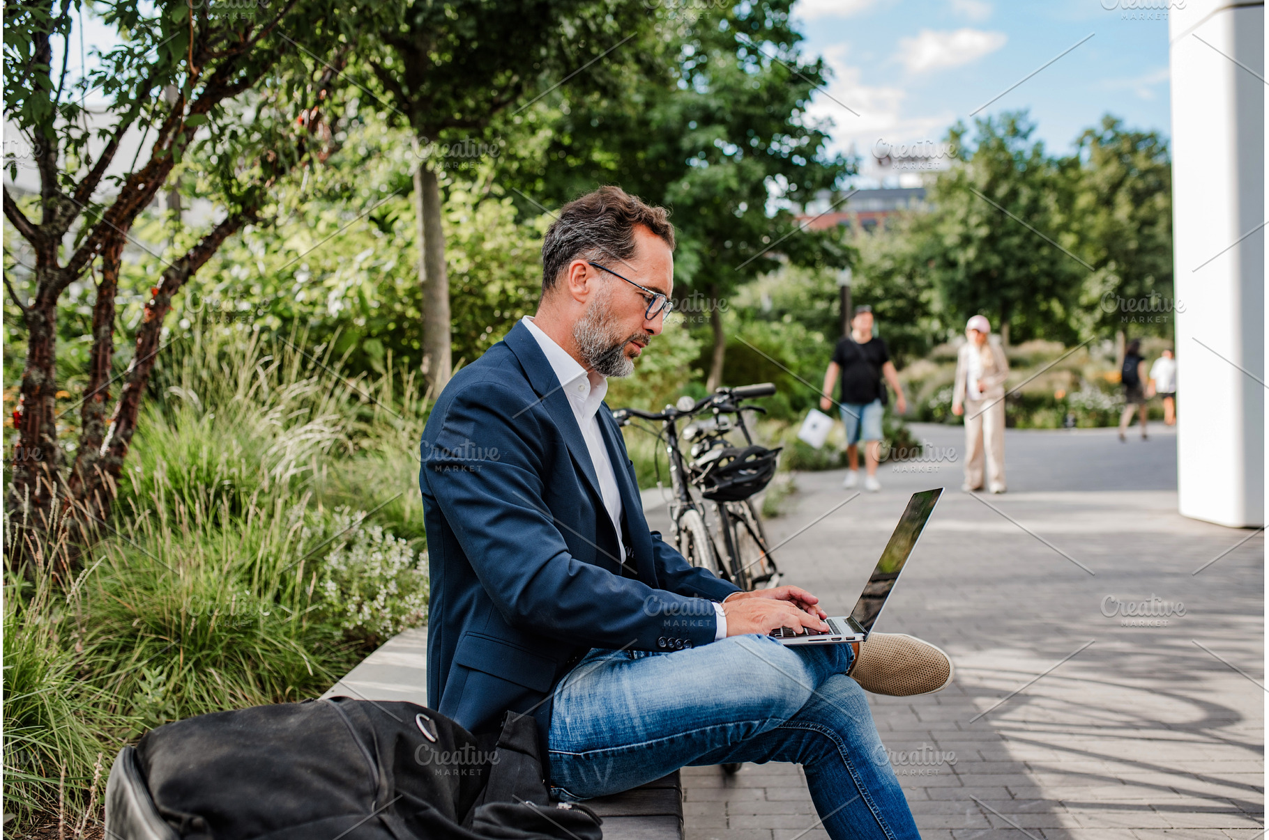 Manager working in urban park, a Business Photo by HalfPoint