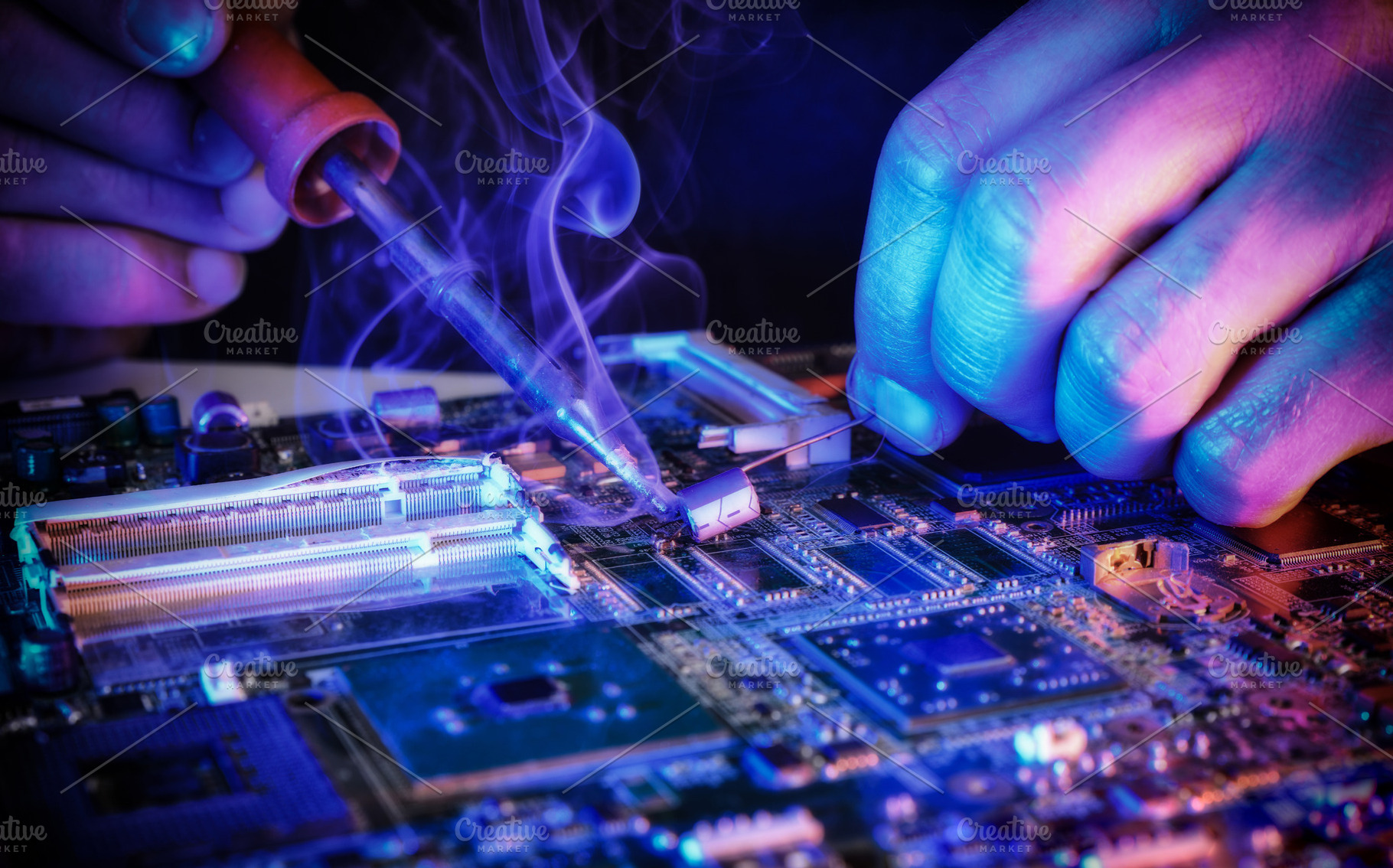 Technician Repairing Laptop Motherboard with Soldering Iron, a Technology Photo by Davizro's Market