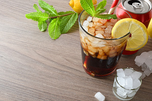 Refreshing cola drink with ice on white table elevated view, a Food & Drink Photo by Davizro's Market