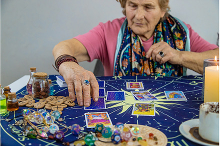 Fortune teller reads tarot cards, a Person Photo by yanadjana