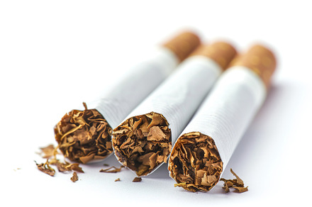 Smoking cigarettes with filter isolated on white background, a Health & Medical Photo by AlyaAnd
