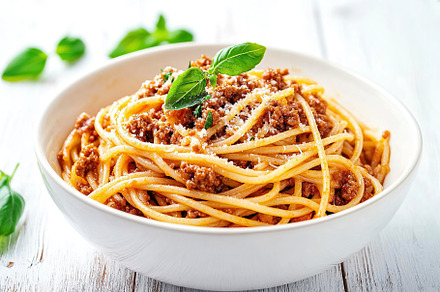 Spaghetti bolognese with ground beef in plate, a Food & Drink Photo by AlyaAnd