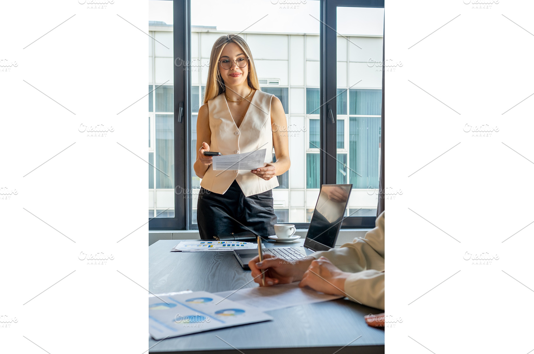 Businesswoman standing and holding, a Business Photo by undrey