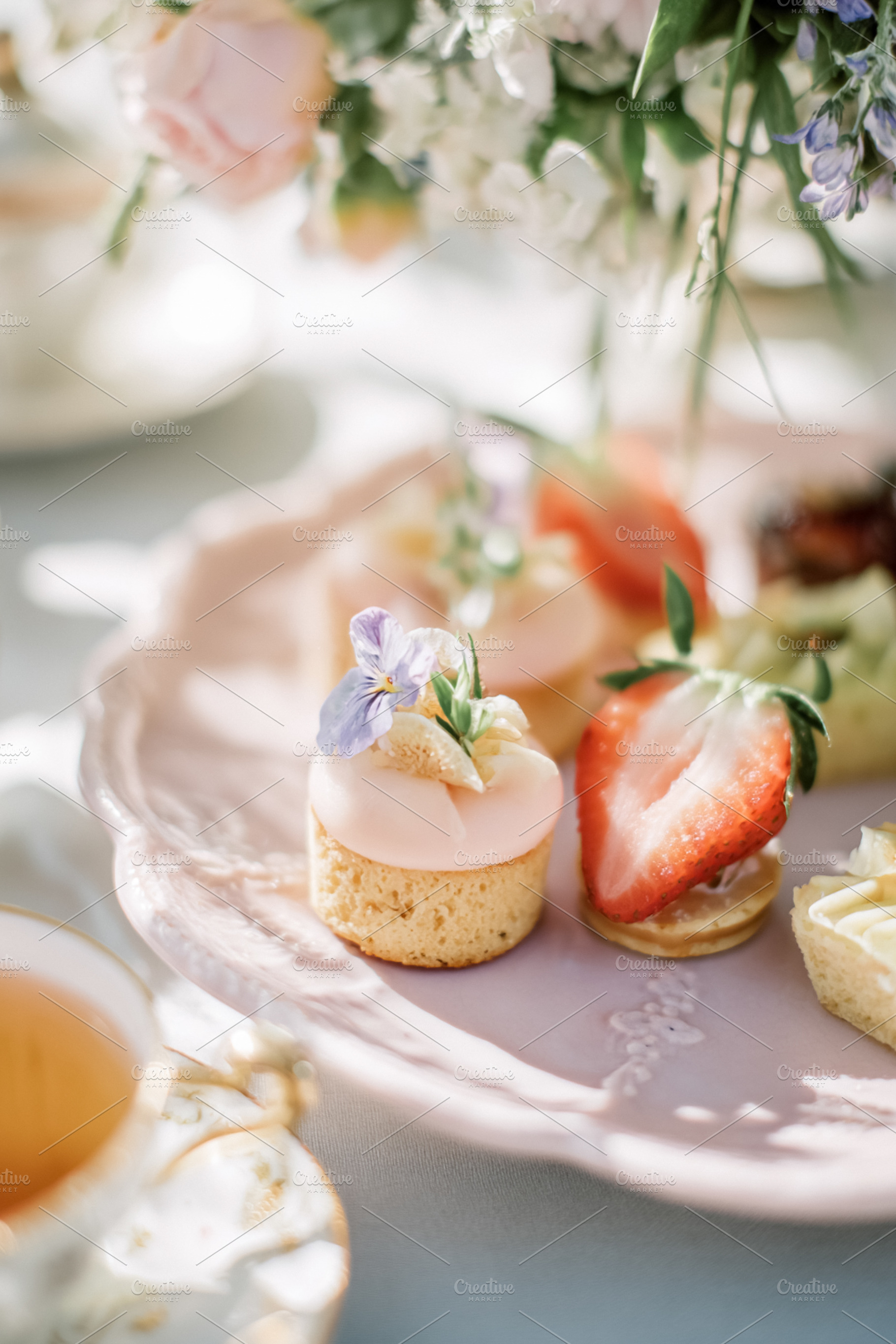 Afternoon tea party setting featuring a close up of dainty petit, a Photo by Studio ANNA