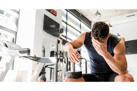 Tired man with dumbbell having break, a Sports & Recreation Photo by Daniel Megias