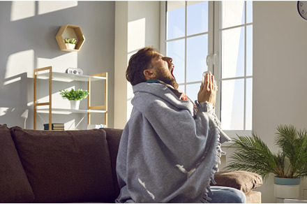Side view shot of sick man sneezing, a Person Photo by StudioRomantic