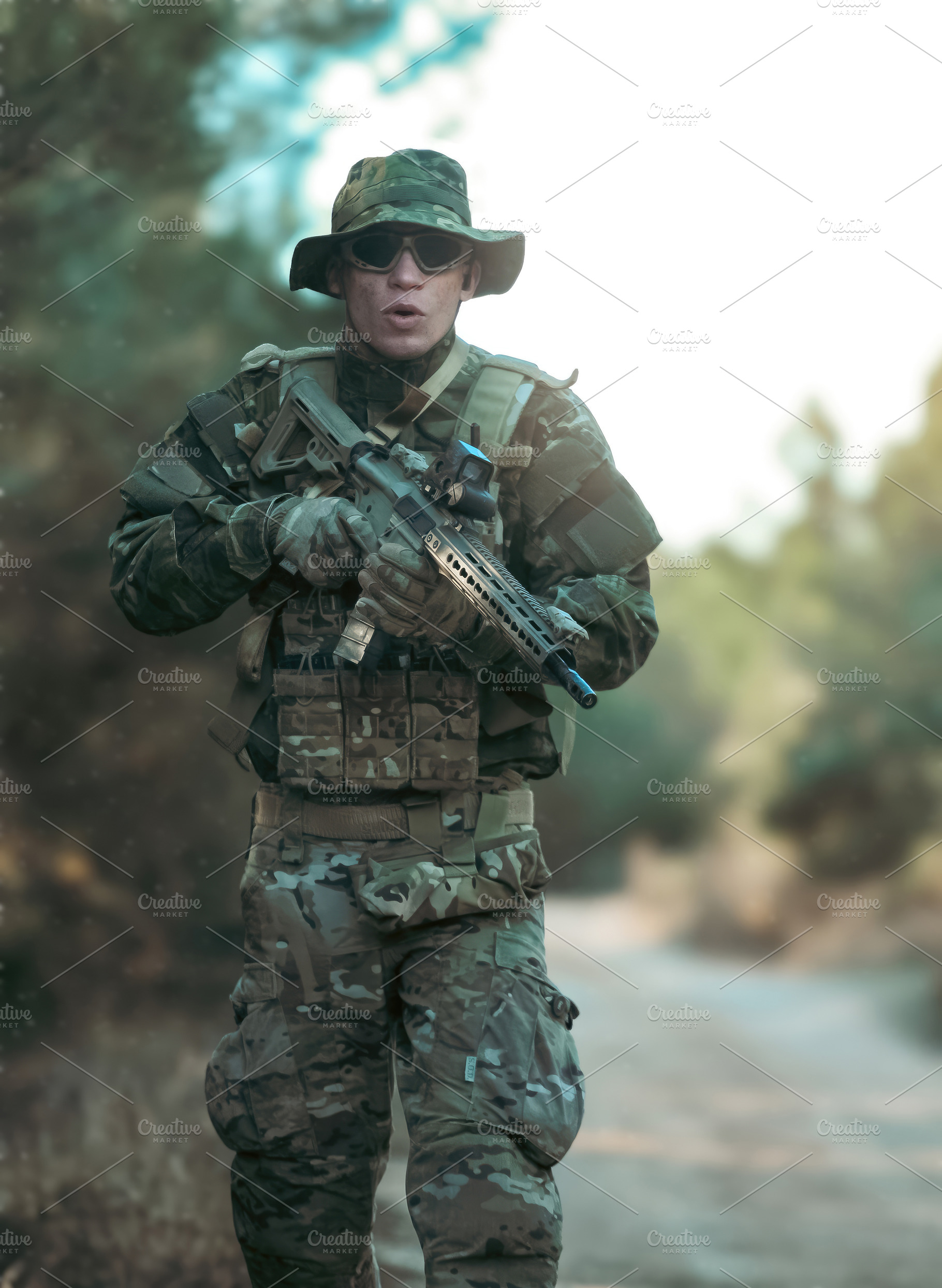 Soldier walking in the forest holding a rifle during airsoft game, a Sports & Recreation Photo by Antonio Gravante Market