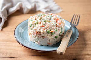 Traditional Russian salad served on plate over wooden table, a Food & Drink Photo by etorres69