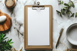 A blank clipboard on a marble surface surrounded by natural elements, perfect f, a Business Photo by ImageMir