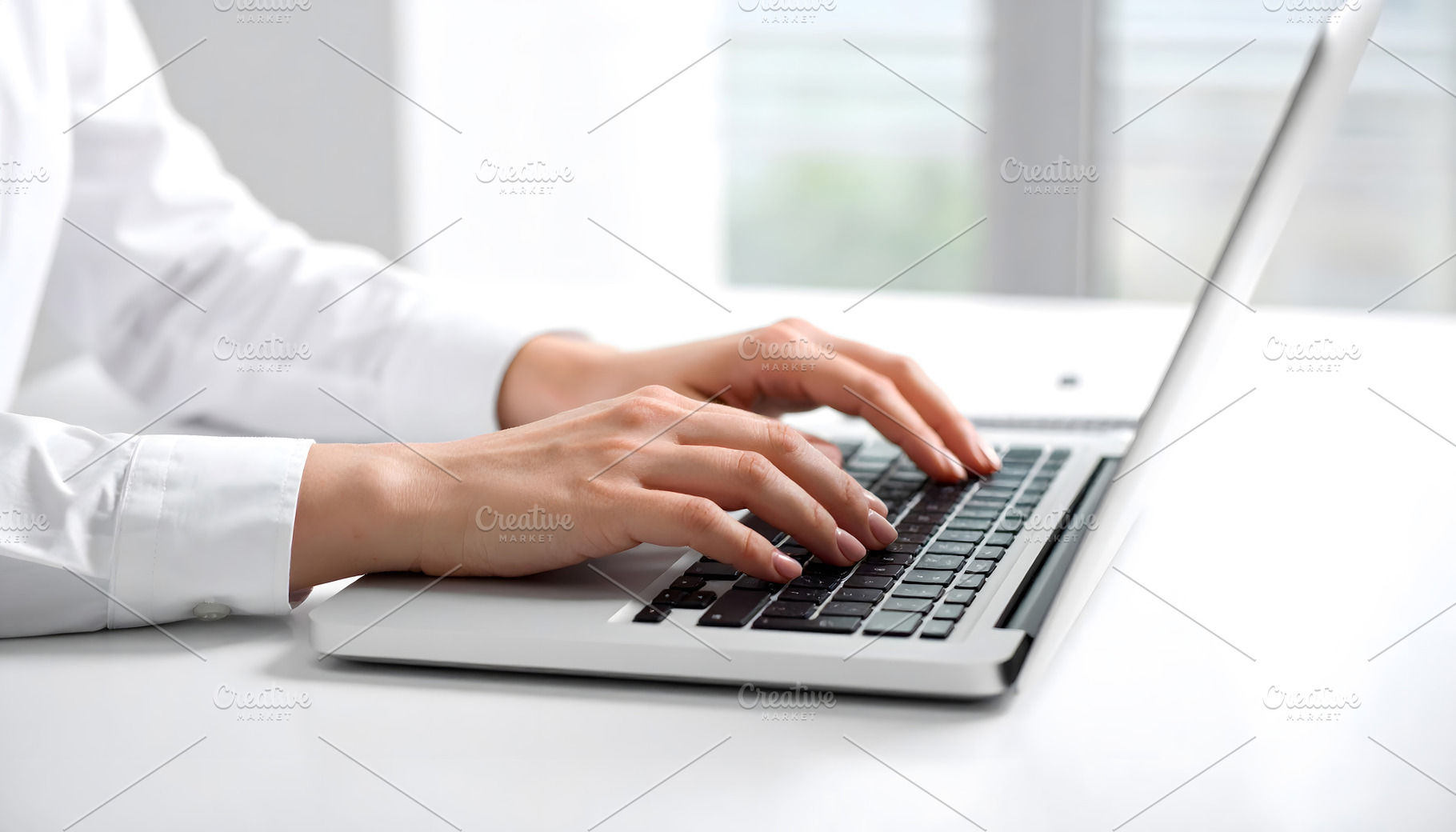 Businesswoman working on laptop at clean bright modern desk, a Business Photo by GoodGoods