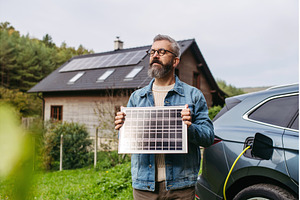 Man holding model of solar panel in, a Transportation Photo by HalfPoint