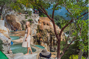 Female tourist exploring Grutas, a Holiday Photo by Elizaveta Galitskaya