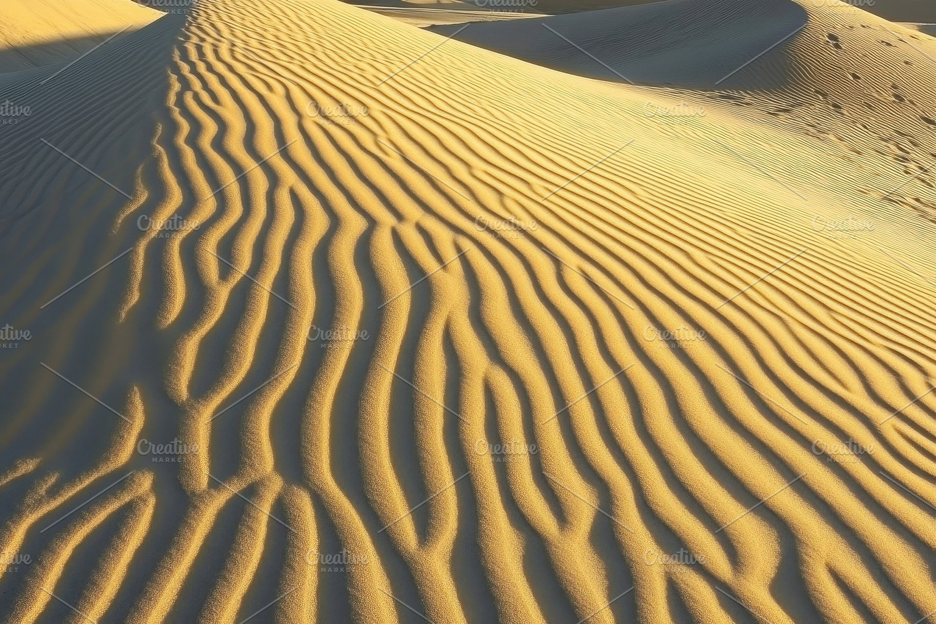 Rippling sand dunes under bright sun, a Photo by Iftikhar Alam