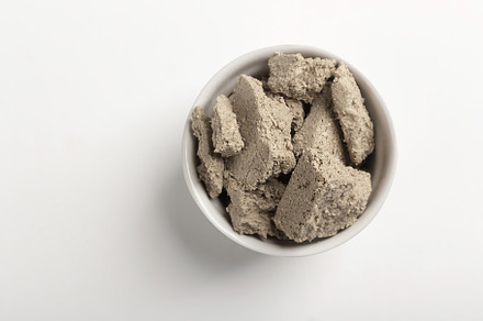 Vegetable-based halva sweet prepared from seeds on white, a Food & Drink Photo by zakiroff