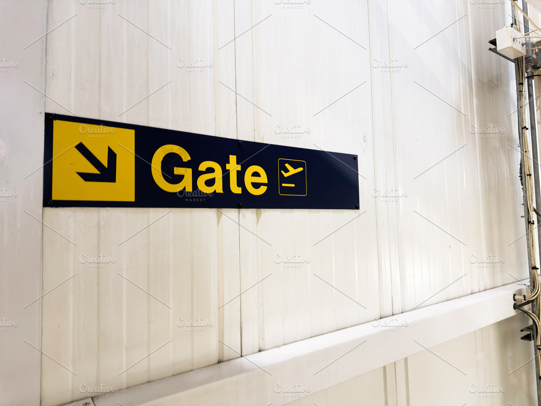Gate sign directing travelers at an airport terminal wall in Manchester with bo, a Photo by AS photostudio