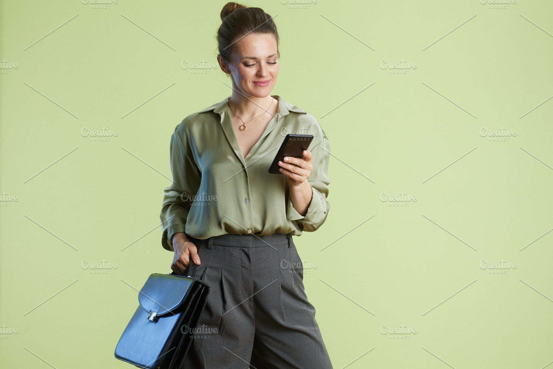Checking messages: Woman and her smartphone, a Business Photo by Alliance Images