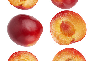 Red whole and halves of plum, isolated background, a Food & Drink Photo by ndanko