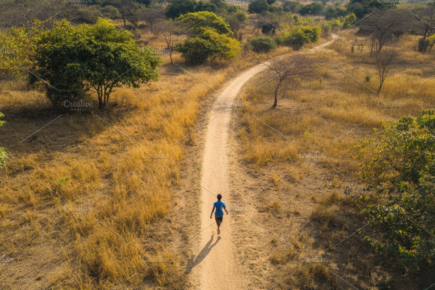 Boy runs down a narrow dirt path thr, a Photo by Iftikhar Alam