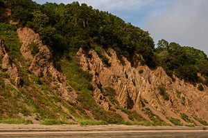 Eroded coastal cliff slope with dens, a Nature Photo by Elena Vagengeim