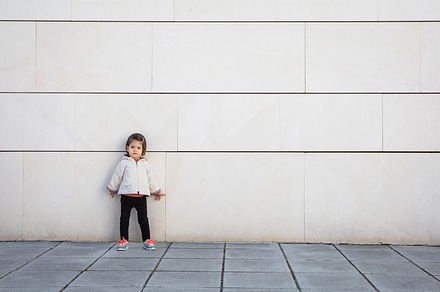 Little girl with sportive look posing over wall containing serious, girl, and, a Person Photo by davidpereiras