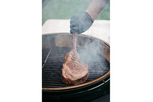 Grilling juicy Tomahawk steak on, a Food & Drink Photo by HalfPoint