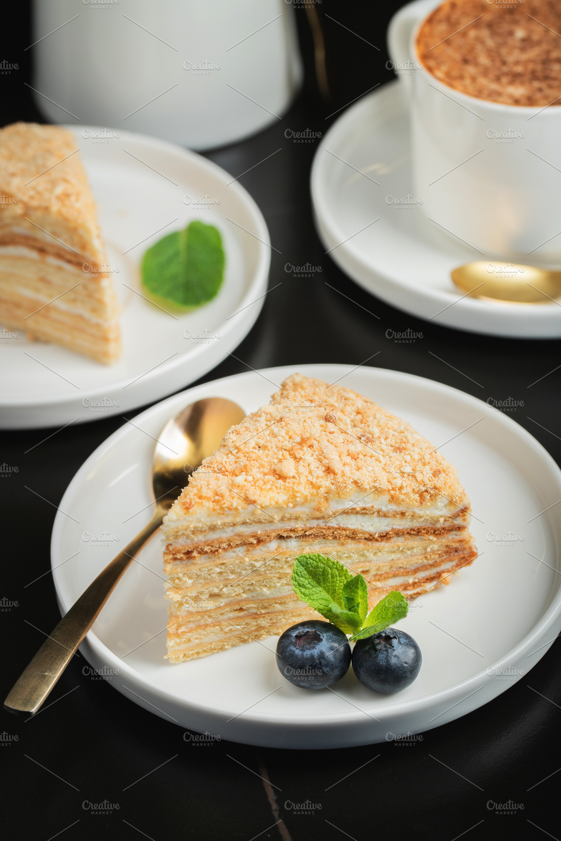 Medovik. Honey cake made from honey cakes with whipped sour cream, decorated wi, a Food & Drink Photo by Budarinphoto